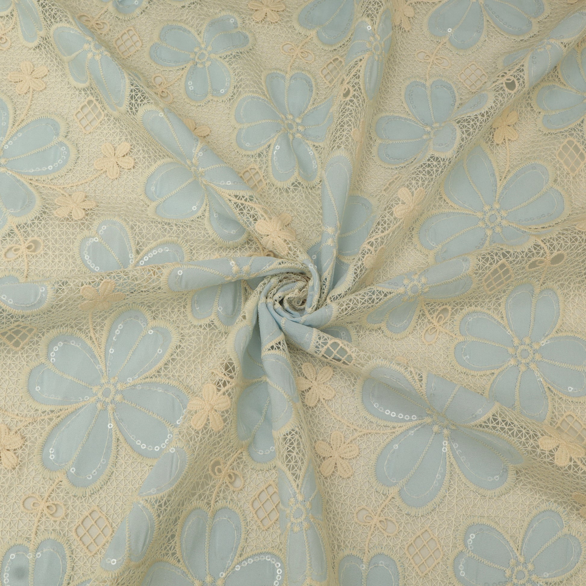 Floral lace fabric with light blue flowers on a beige background