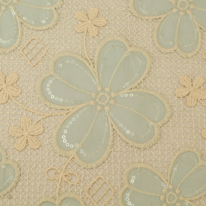 Decorative fabric with floral patterns in green and beige on a beige background