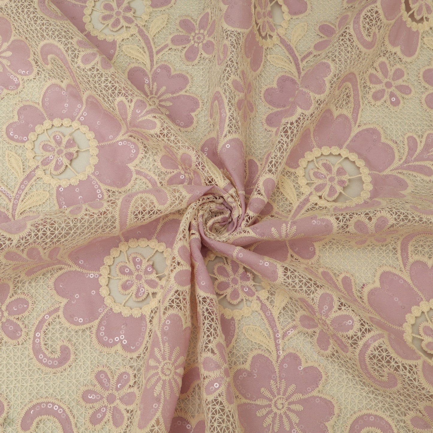 Lace fabric with pink floral pattern on beige background