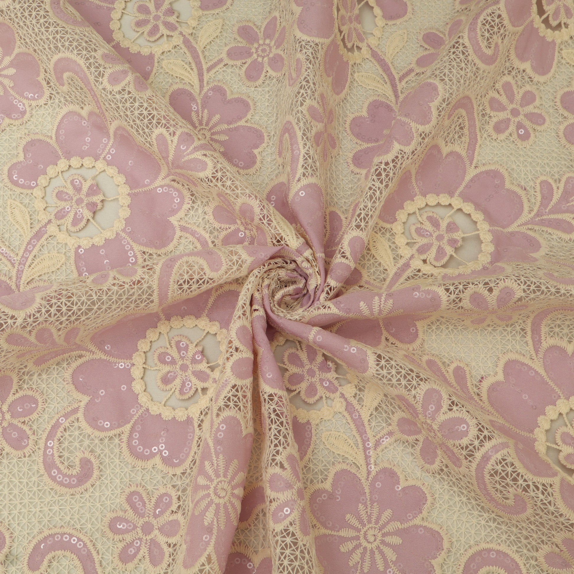 Lace fabric with pink floral pattern on beige background