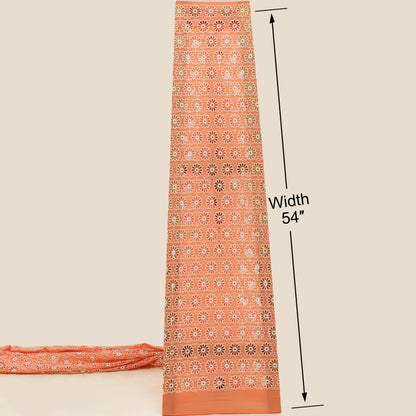 Orange fabric with a pattern and measurement label on a beige background