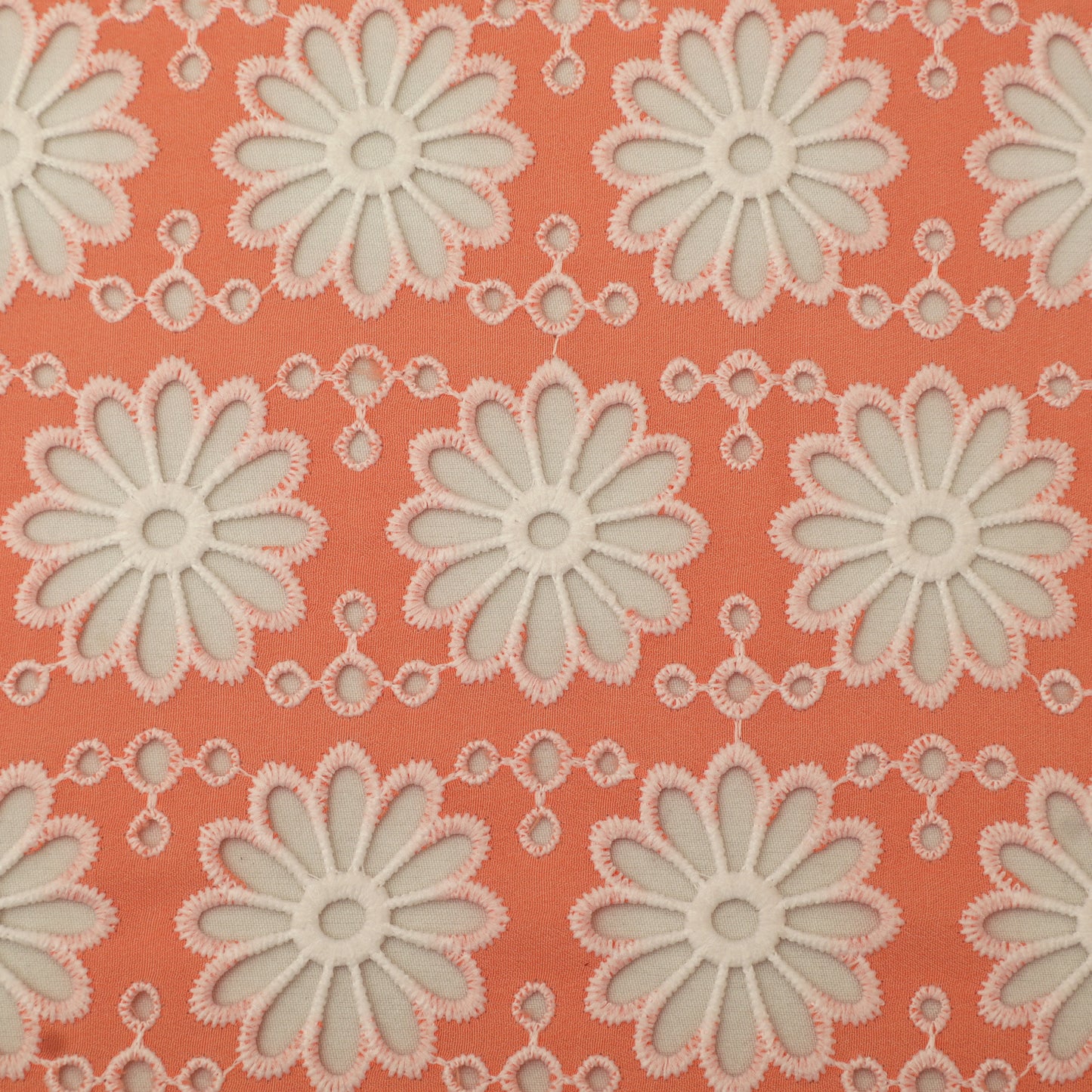 Pattern of white flowers on a coral background