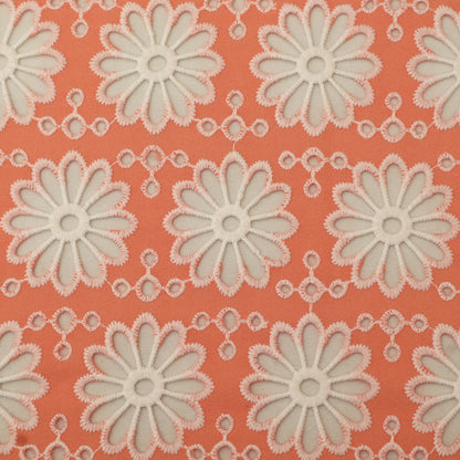 Pattern of white flowers on a coral background