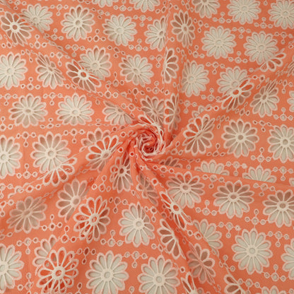 Floral patterned fabric with white flowers on a peach background