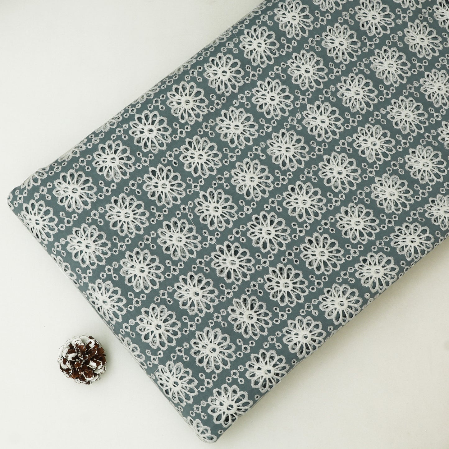 Fabric with white floral pattern on a gray background