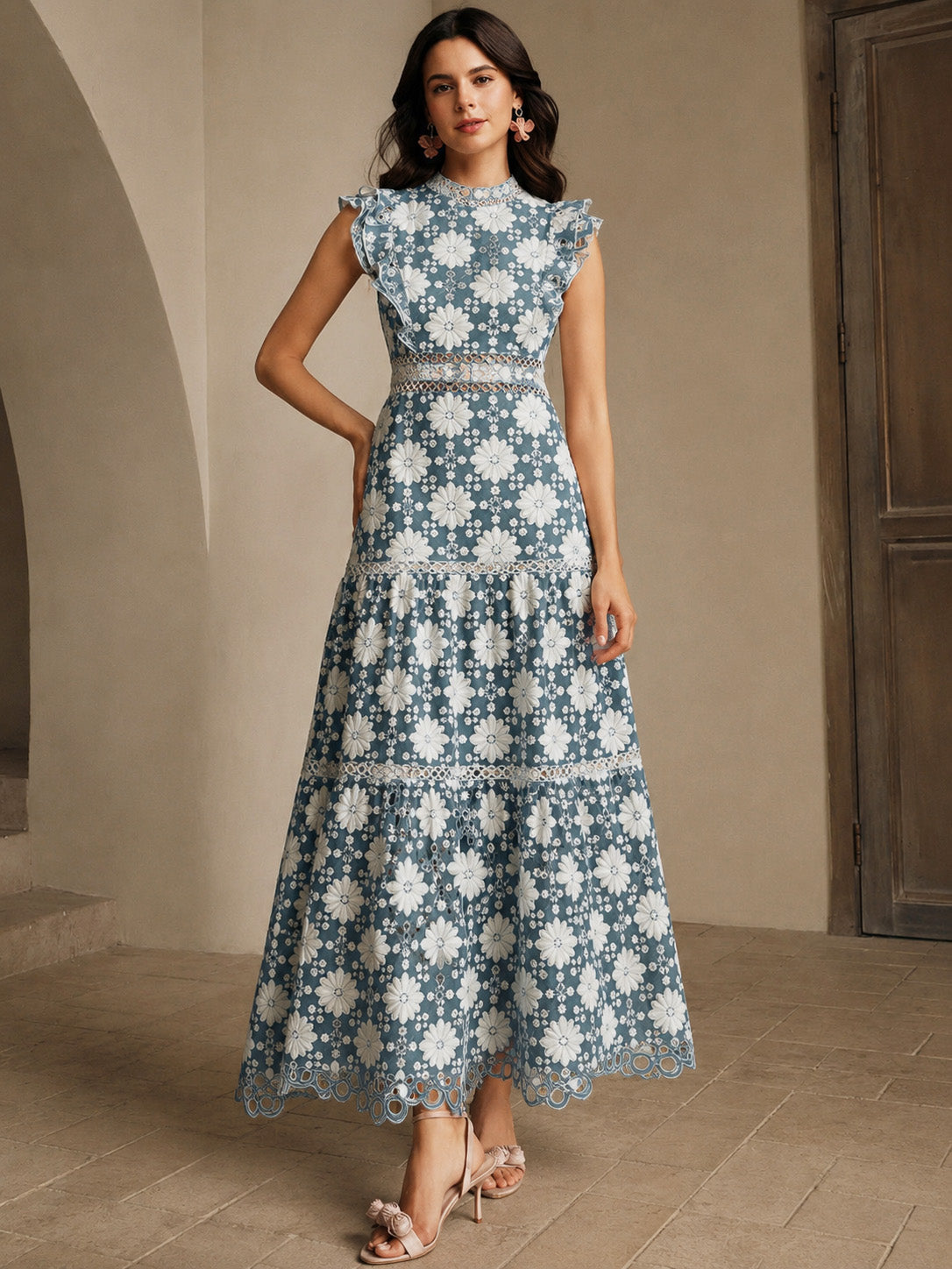 Woman wearing a blue floral dress in an indoor setting