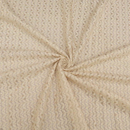 Beige fabric with a subtle pattern, swirled for display