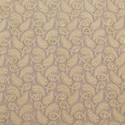 Patterned fabric with beige paisley design on a beige background