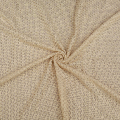 Close-up of beige fabric with a swirling pattern