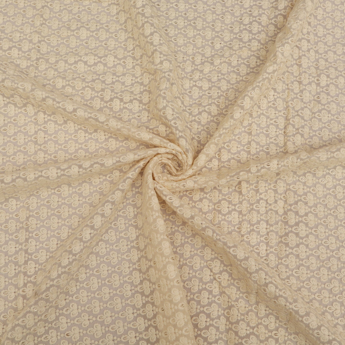 Beige fabric with a subtle pattern, possibly floral or abstract, in a swirled arrangement.