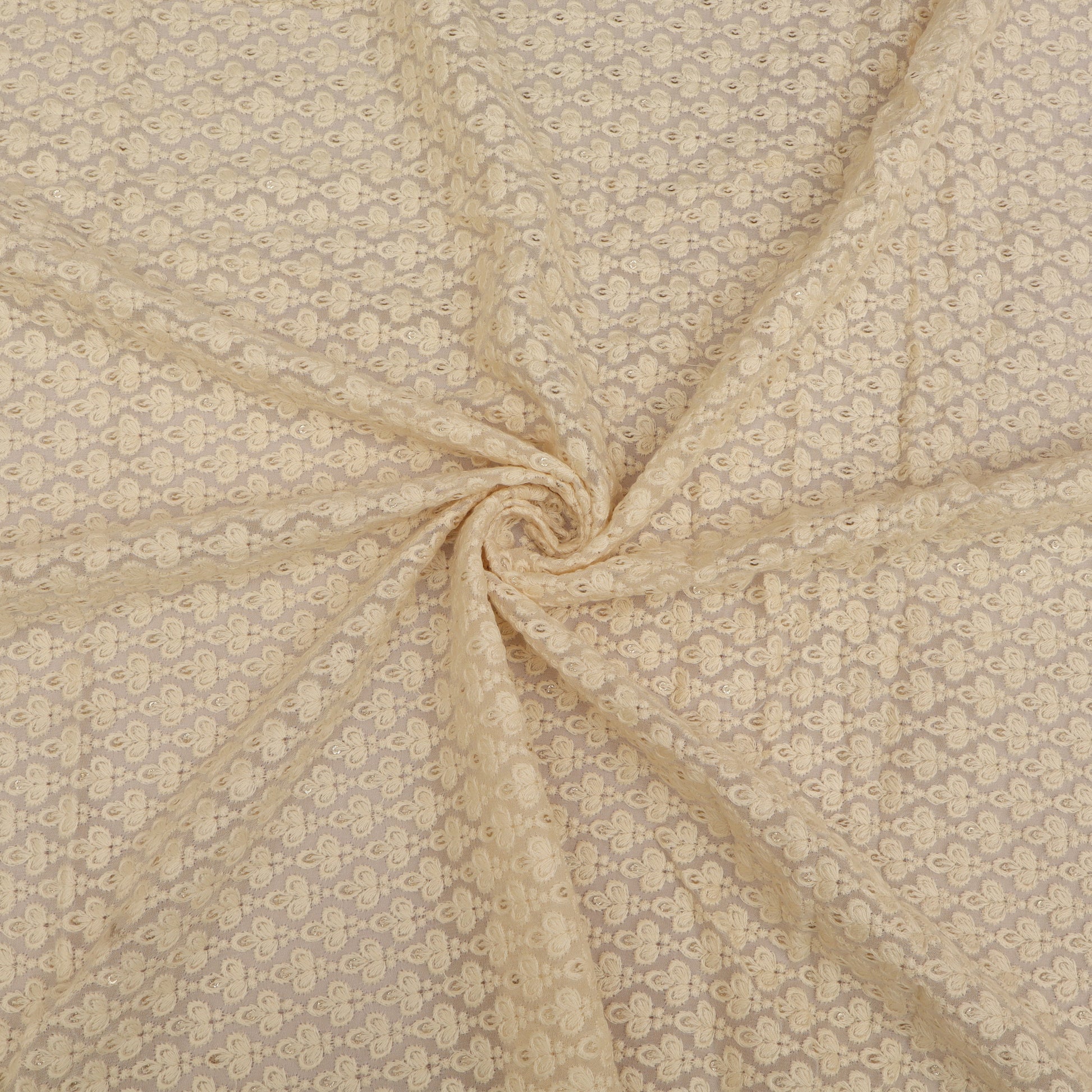 Beige fabric with a subtle pattern, possibly floral or abstract, in a swirled arrangement.
