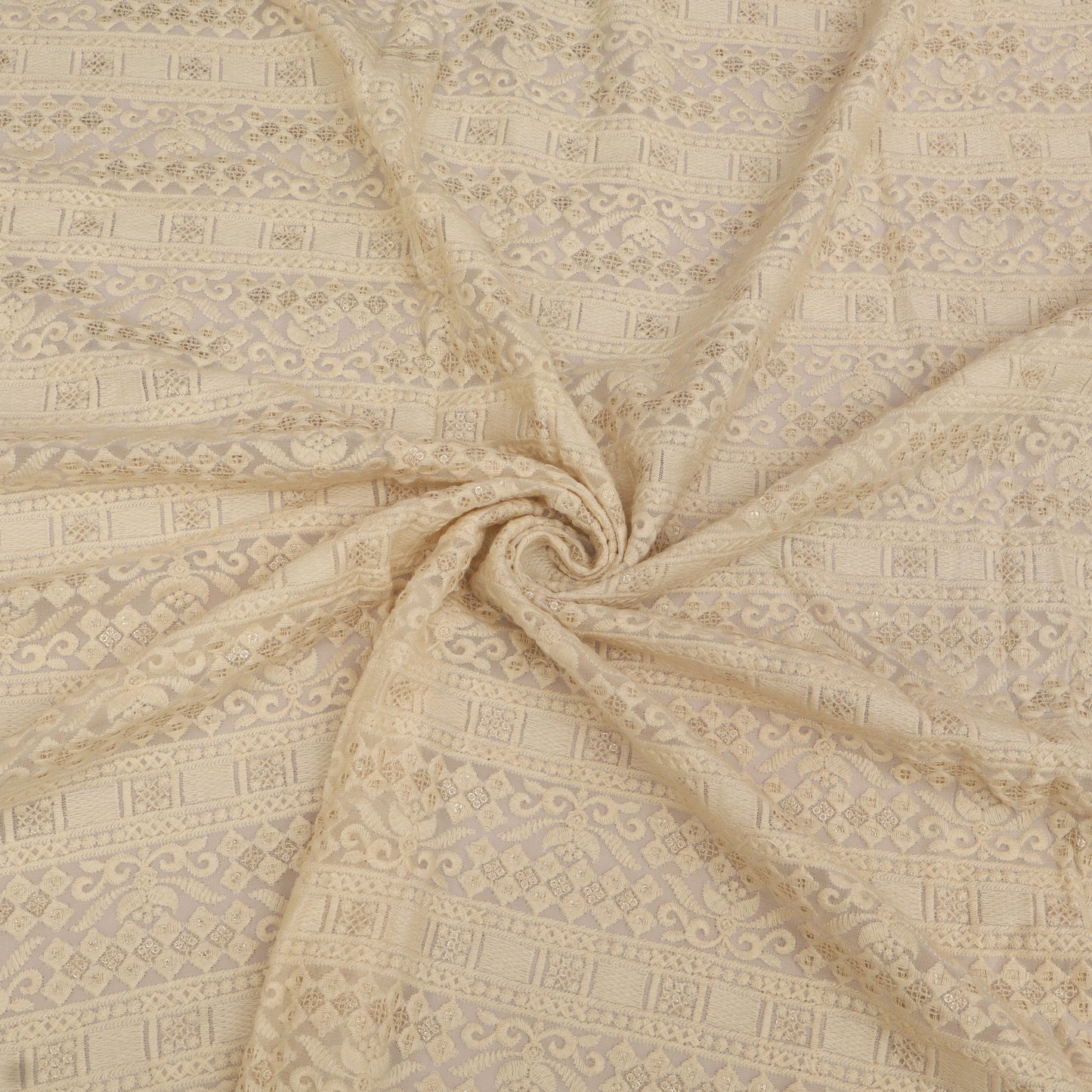 Patterned fabric with a swirling design in beige tones