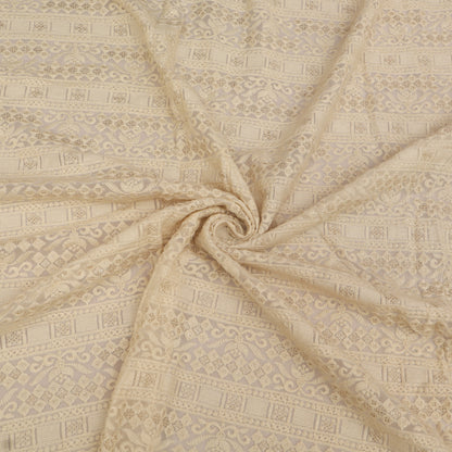 Patterned fabric with a swirling design in beige tones