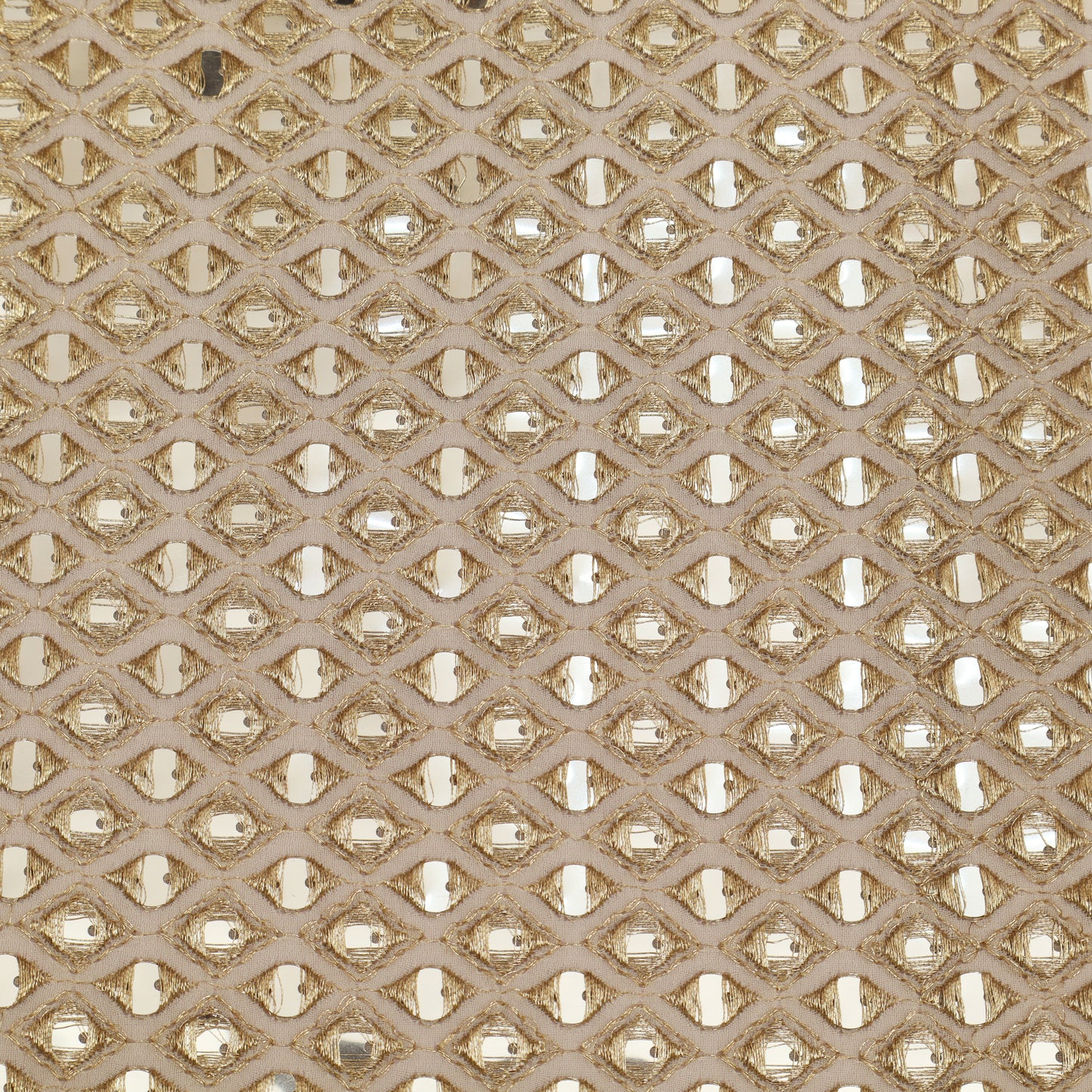 Patterned fabric with a geometric design in beige and gold tones