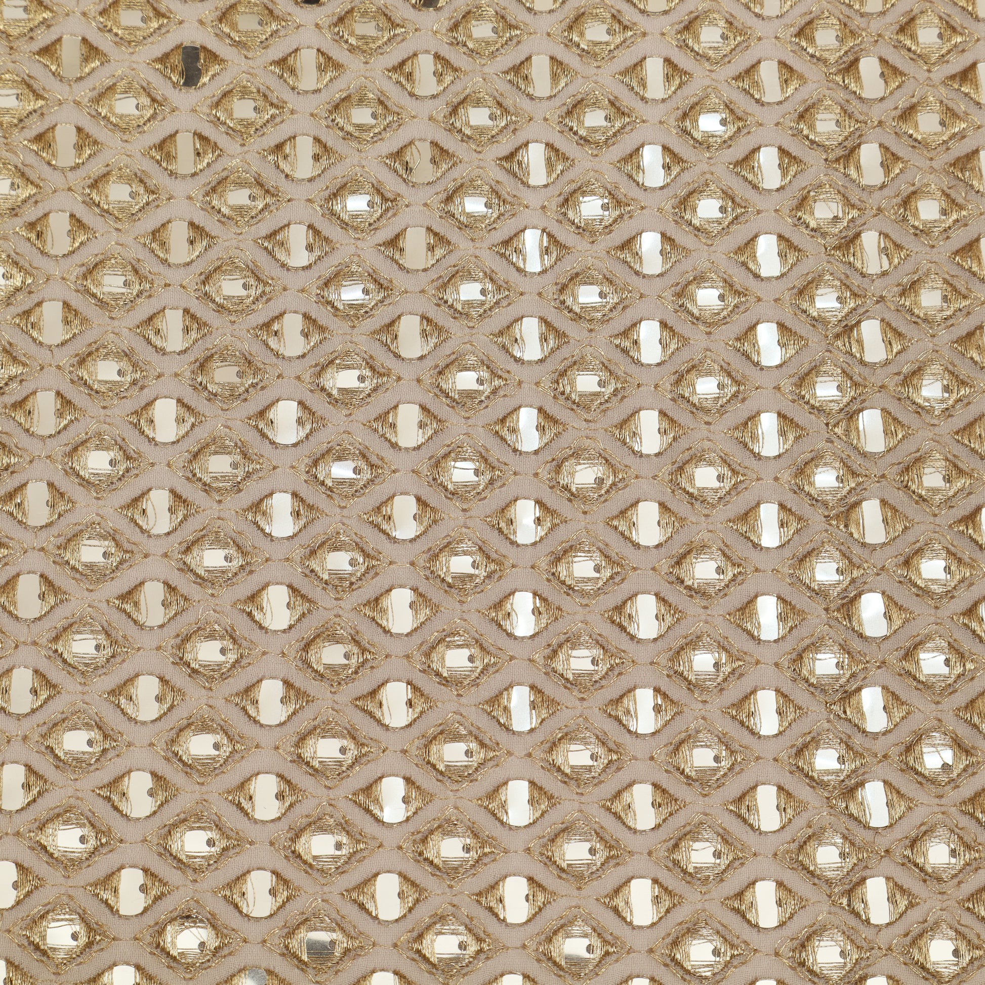 Patterned fabric with a geometric design in beige and gold tones