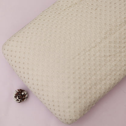 Textured beige pillow on a pink background with a pine cone
