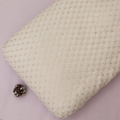 Textured pillow with a small pine cone on a light purple background