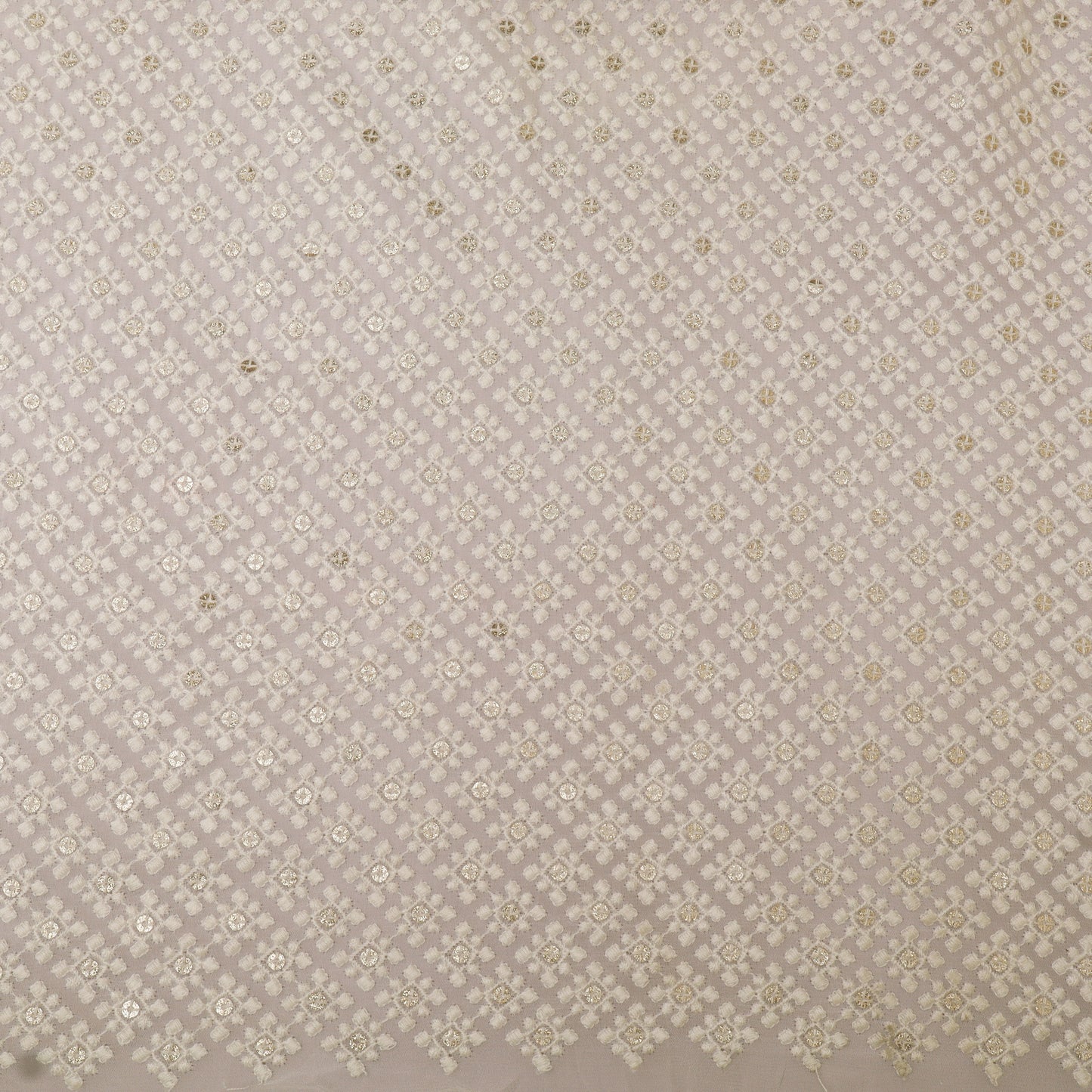 Patterned fabric swatch with small geometric design on a beige background