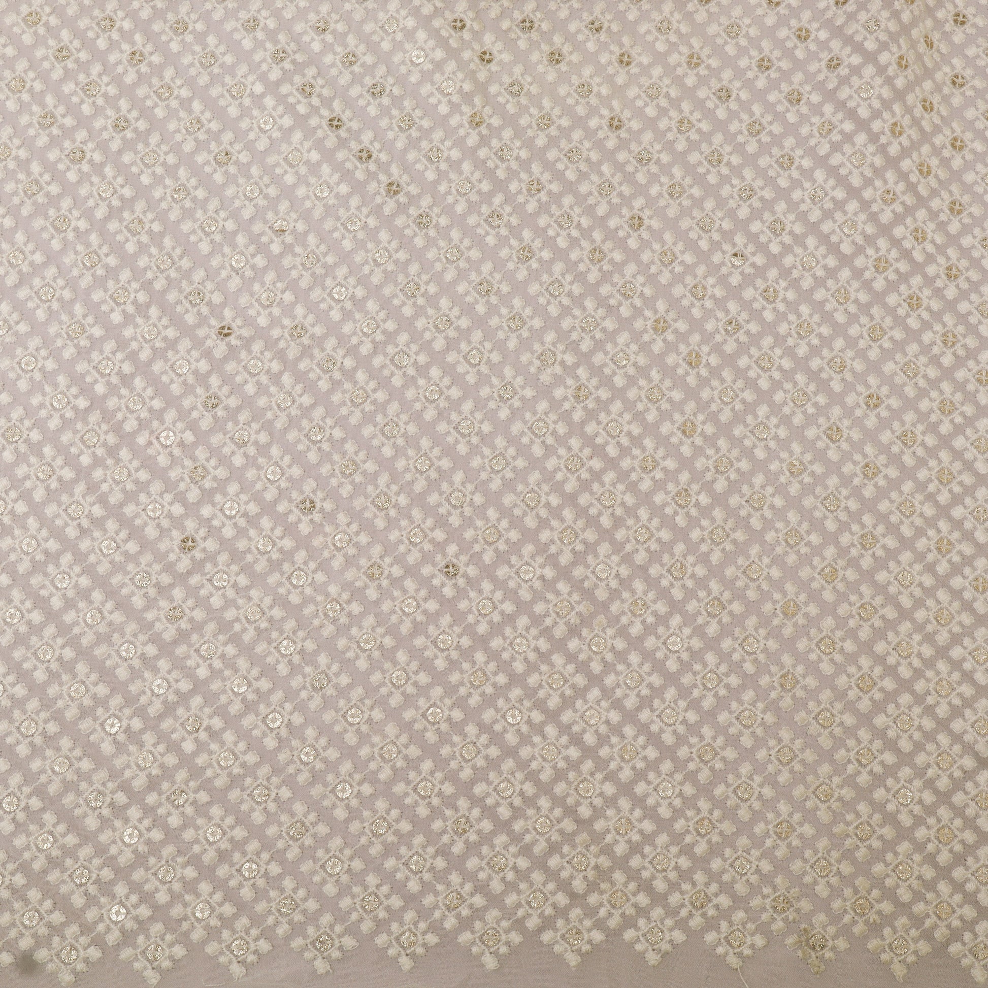 Patterned fabric swatch with small geometric design on a beige background