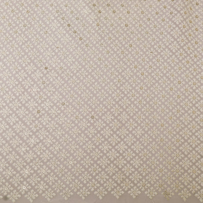 Patterned fabric swatch with small geometric design on a beige background