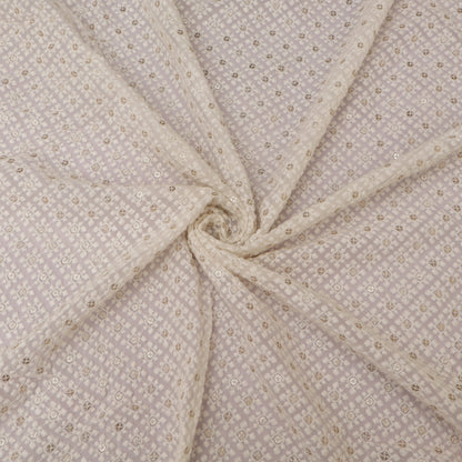 Close-up of beige fabric with subtle pattern on a White background