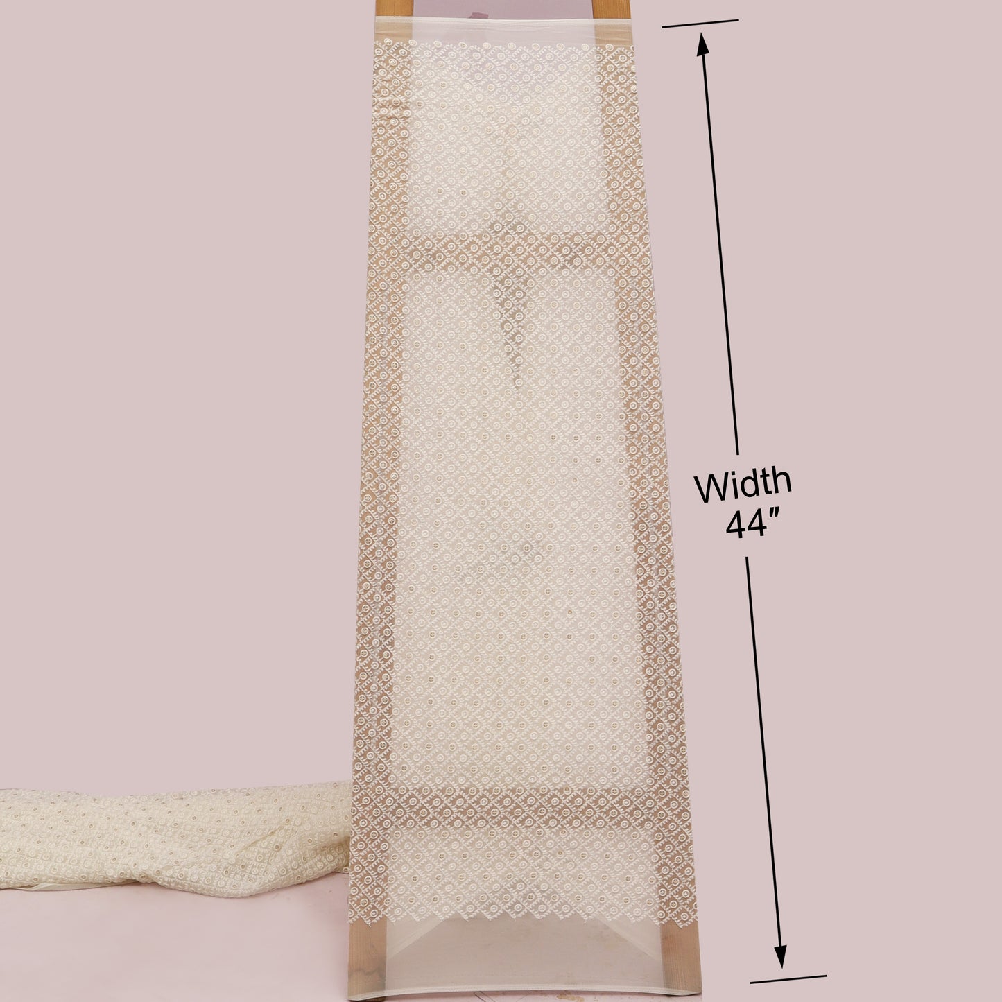 Beige towel with decorative border and measurement label on a White background