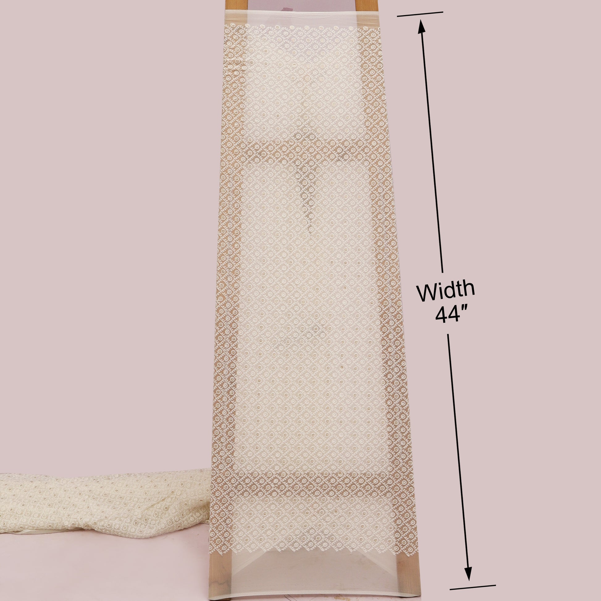 Beige towel with decorative border and measurement label on a White background
