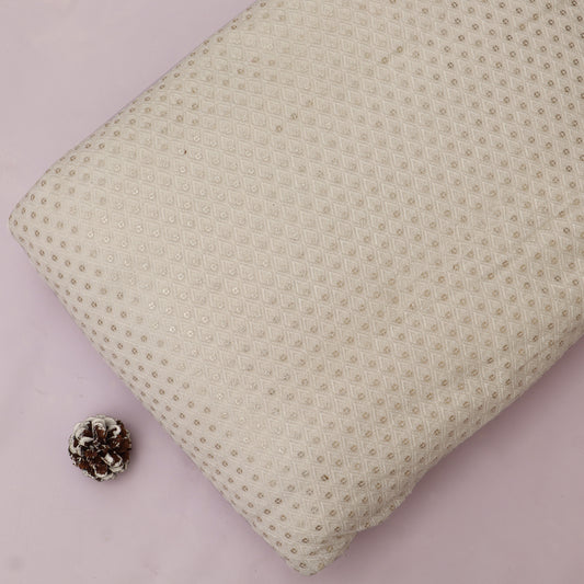 Textured beige pillow on a pink background with a pine cone