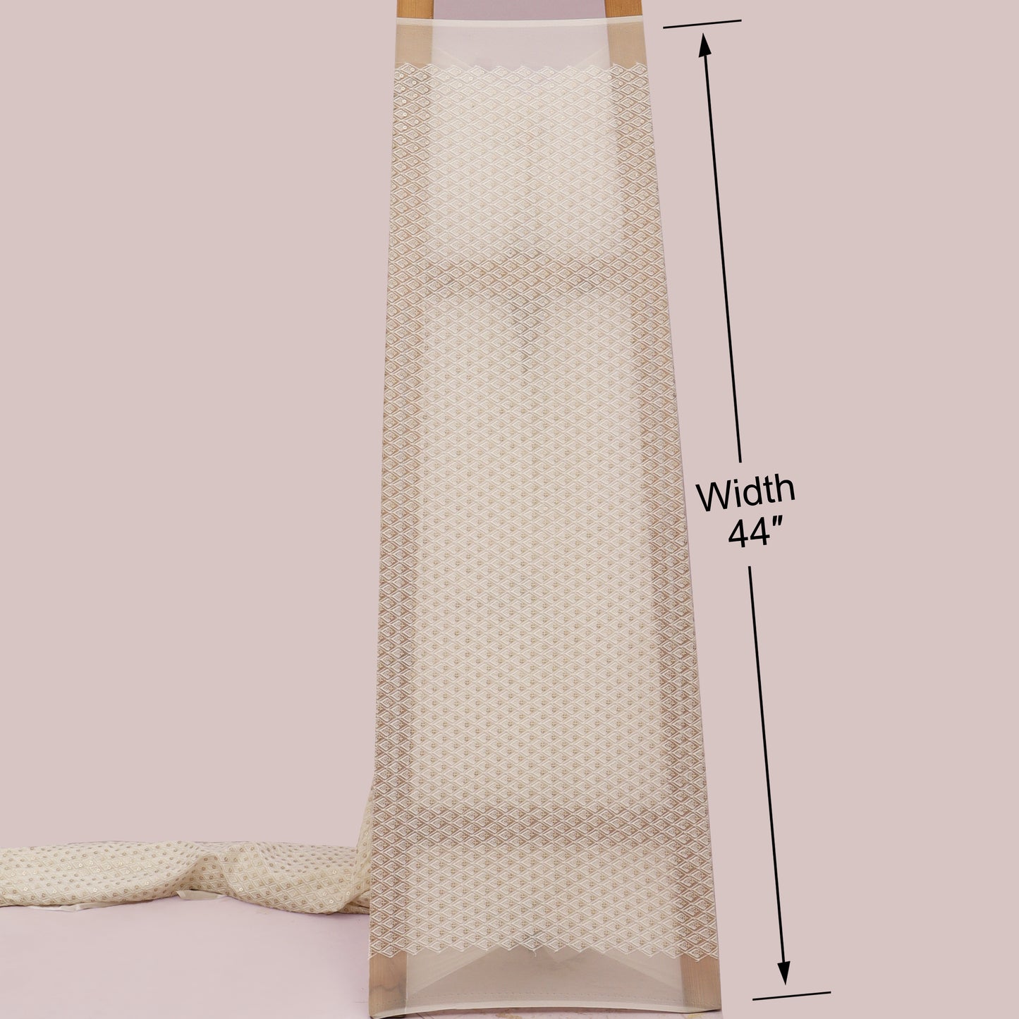 Beige textured fabric with a measurement label indicating width 44 inches on a light pink background.