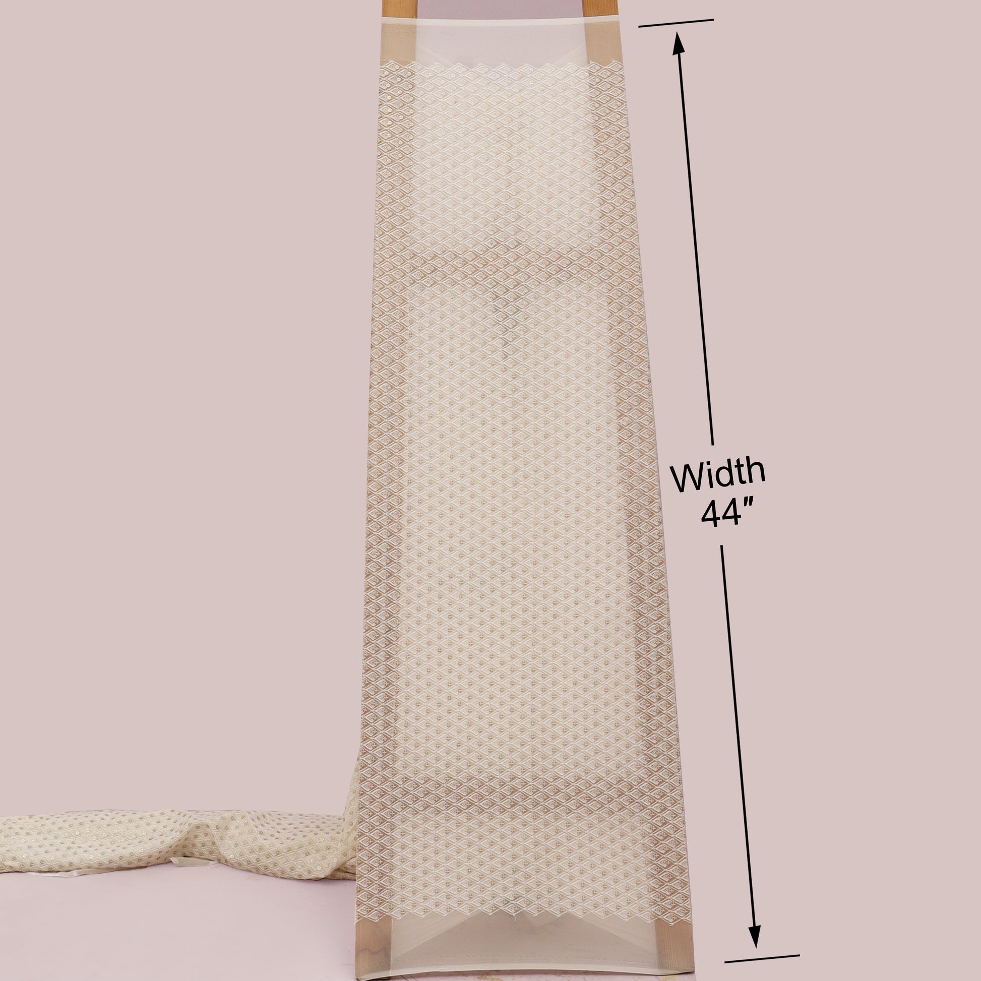 Beige textured fabric with a measurement label indicating width 44 inches on a light pink background.