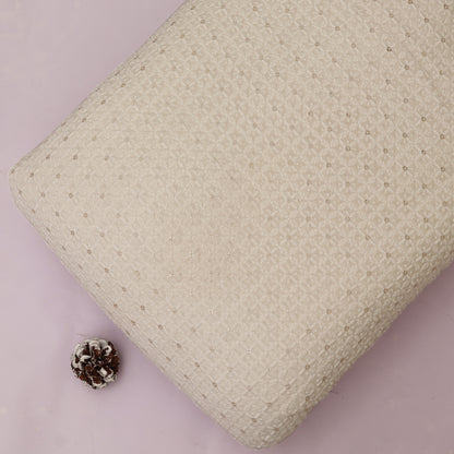 Textured White pillow on a White background with a pine cone.