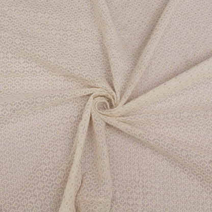 White  fabric with a subtle pattern, folded in a way that highlights its texture.