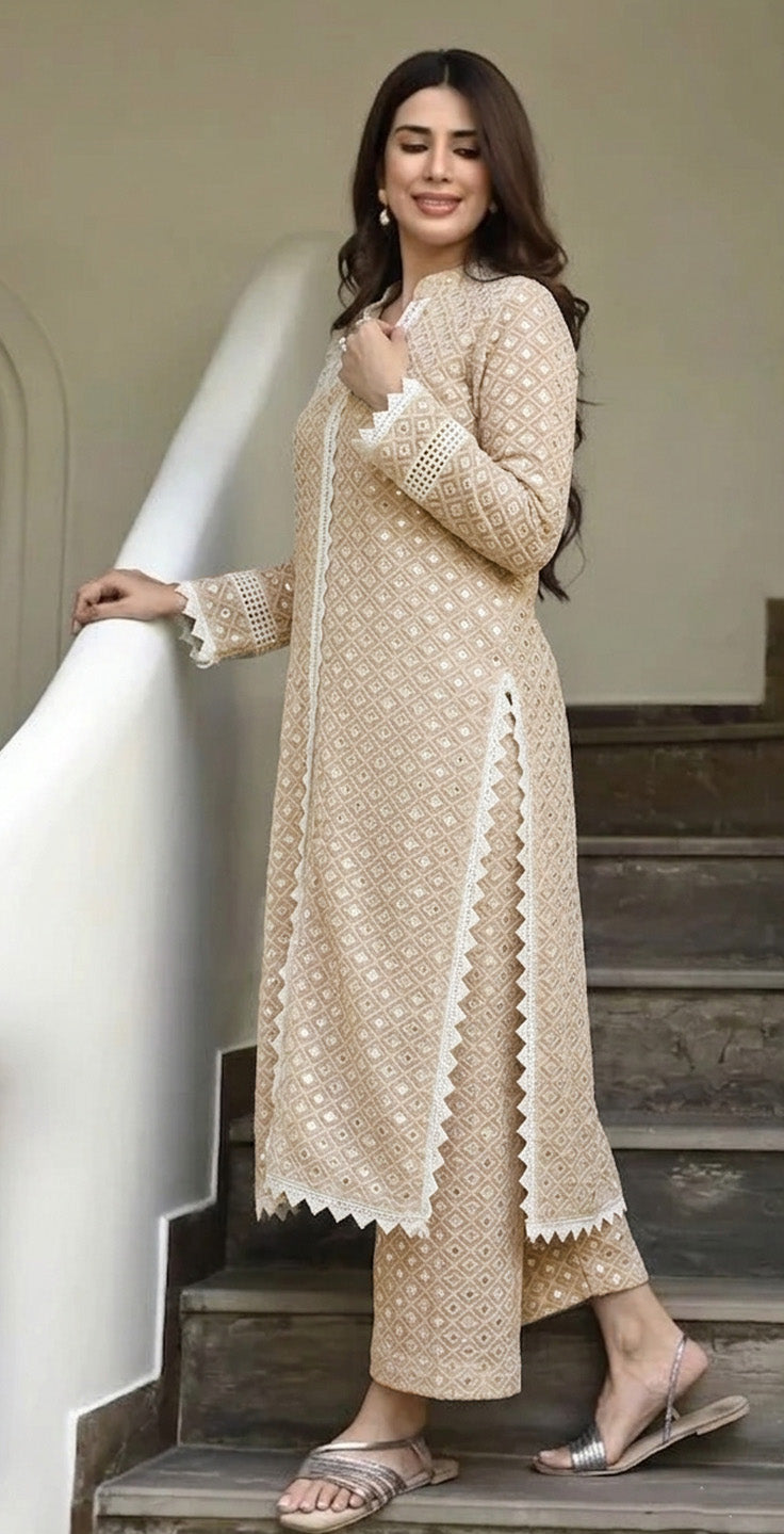 Woman in a White  embroidered outfit standing on a staircase.