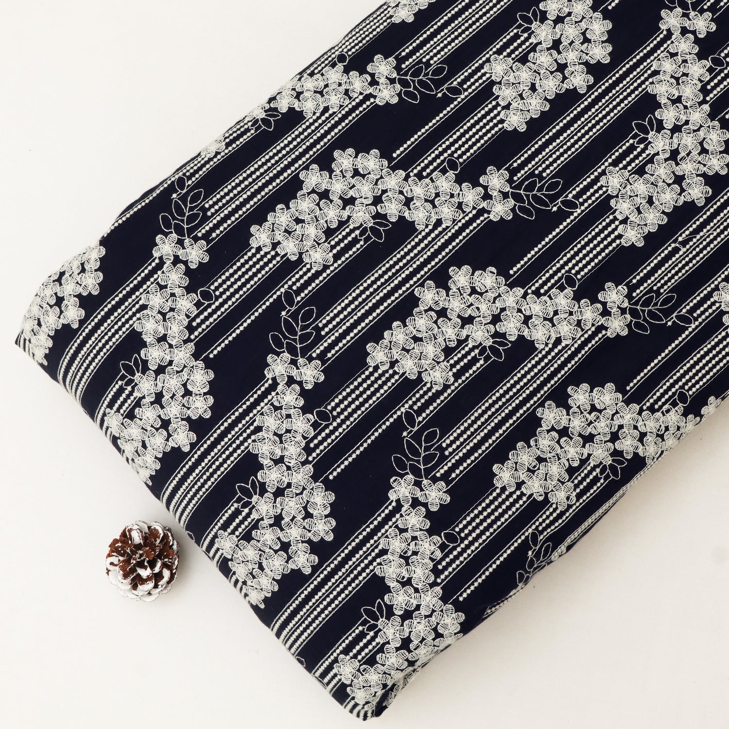 Navy fabric with white floral pattern on a white background
