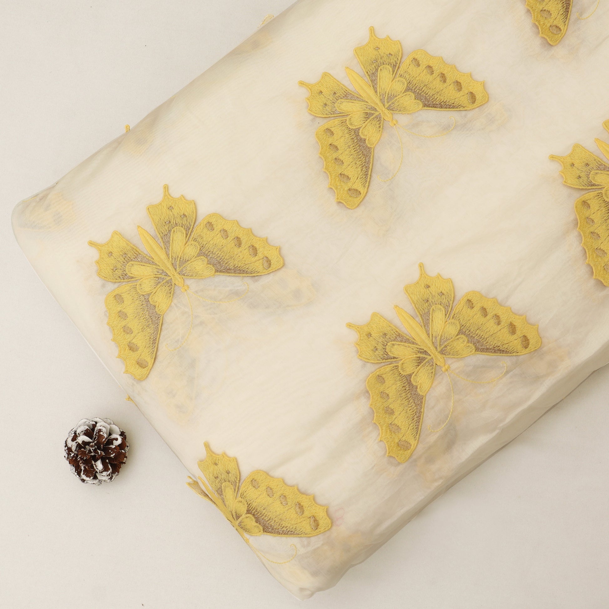 Butterfly-patterned fabric with yellow butterflies on a white background