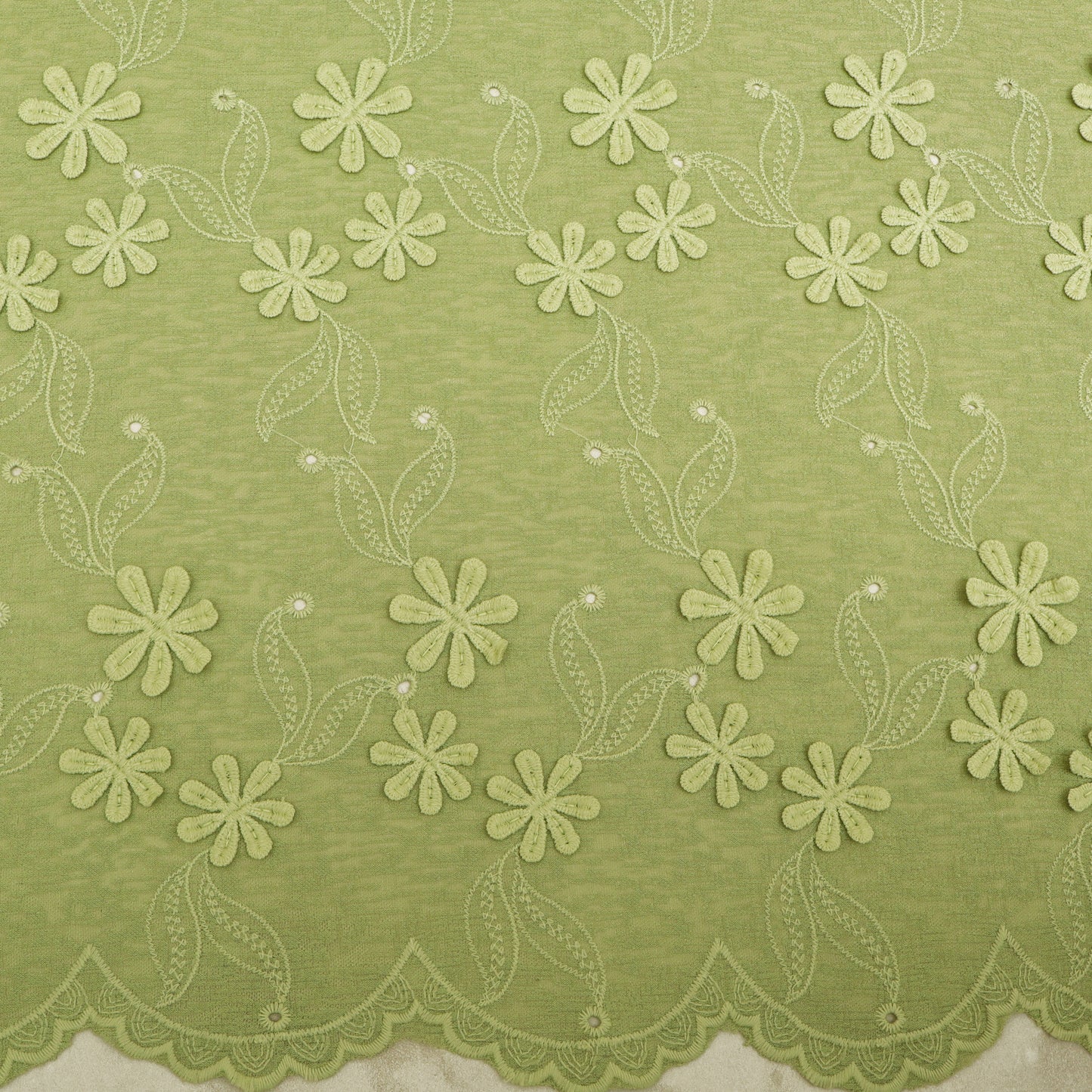 Green fabric with floral lace pattern