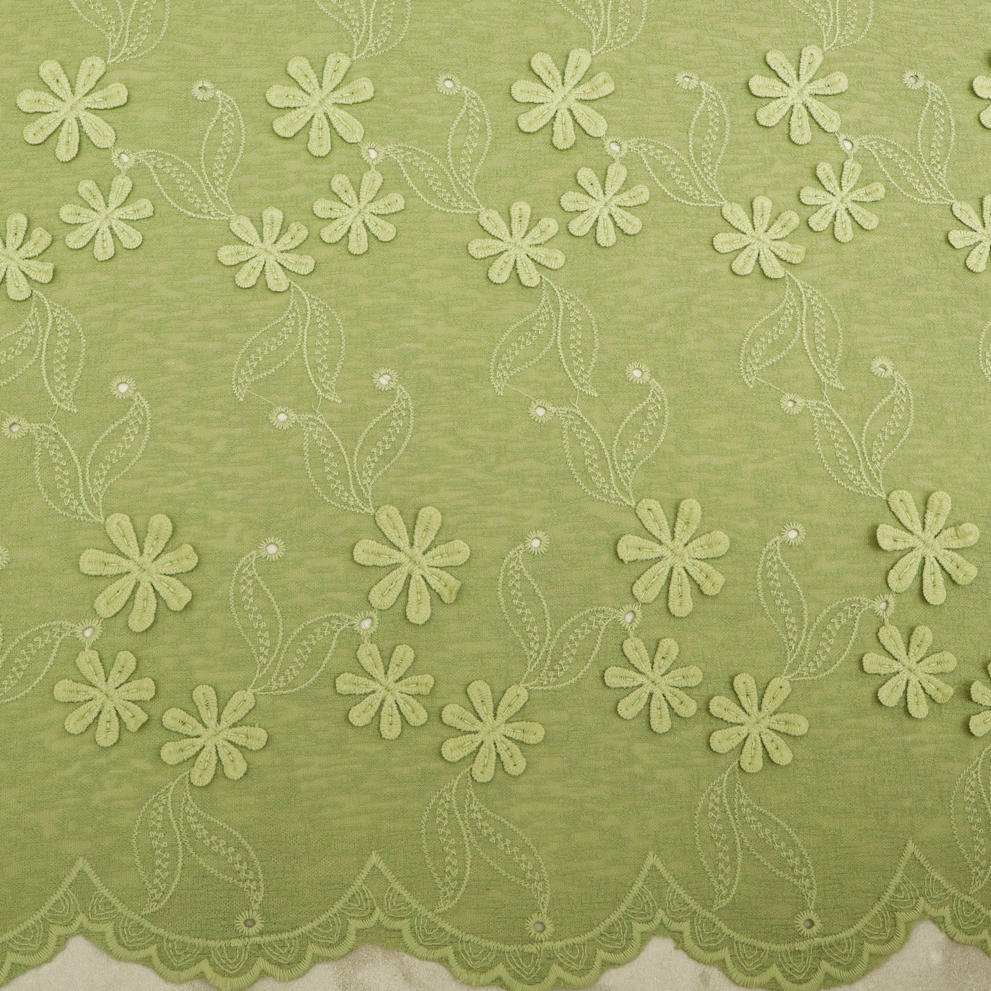 Green fabric with floral lace pattern