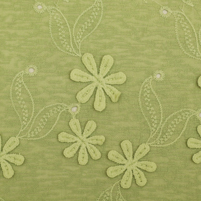 Green fabric with embroidered flowers and leaves