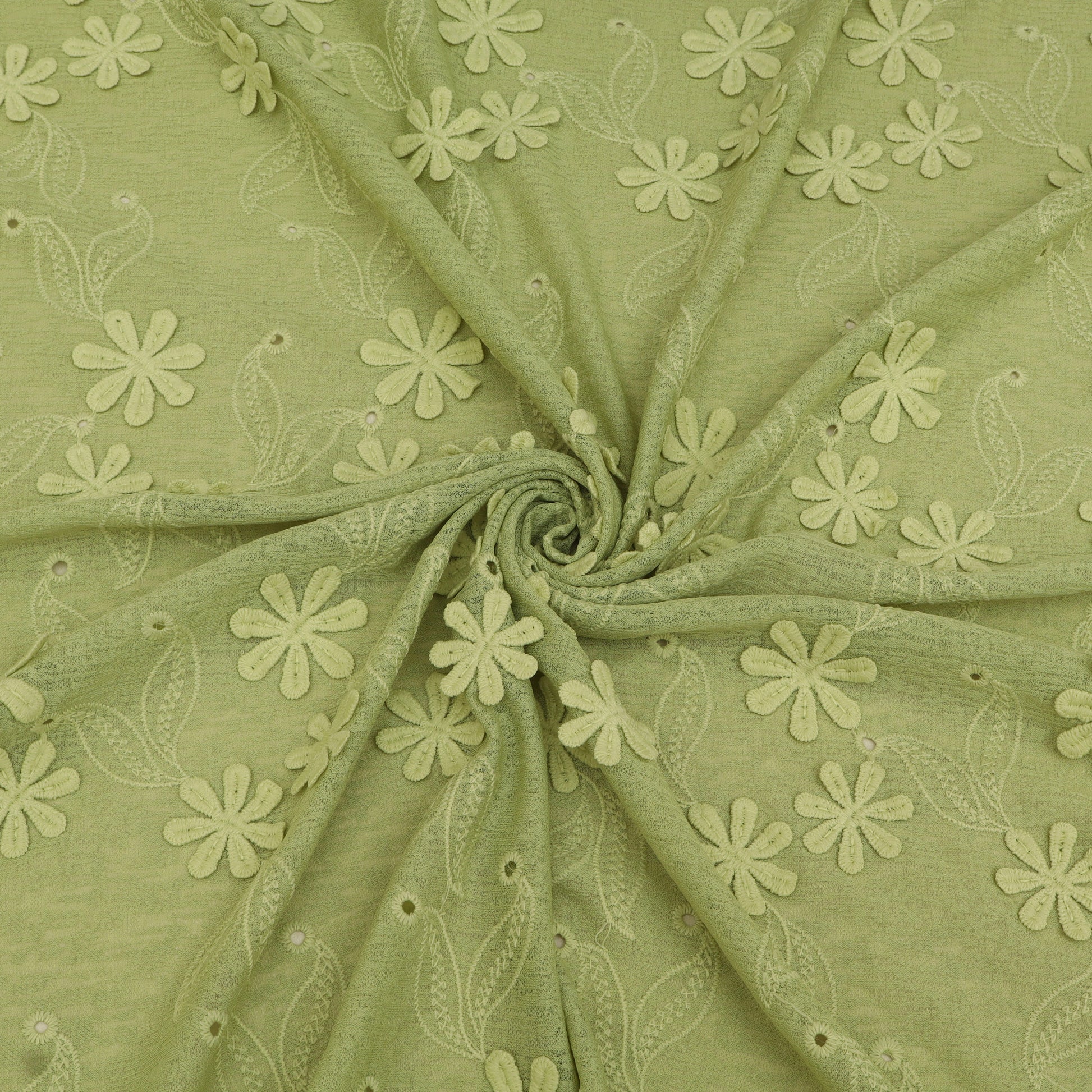Green fabric with floral embroidery pattern