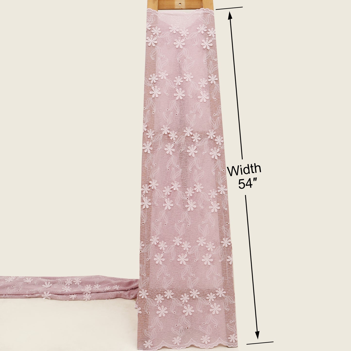 Pink lace fabric with white floral patterns and measurements on a beige background
