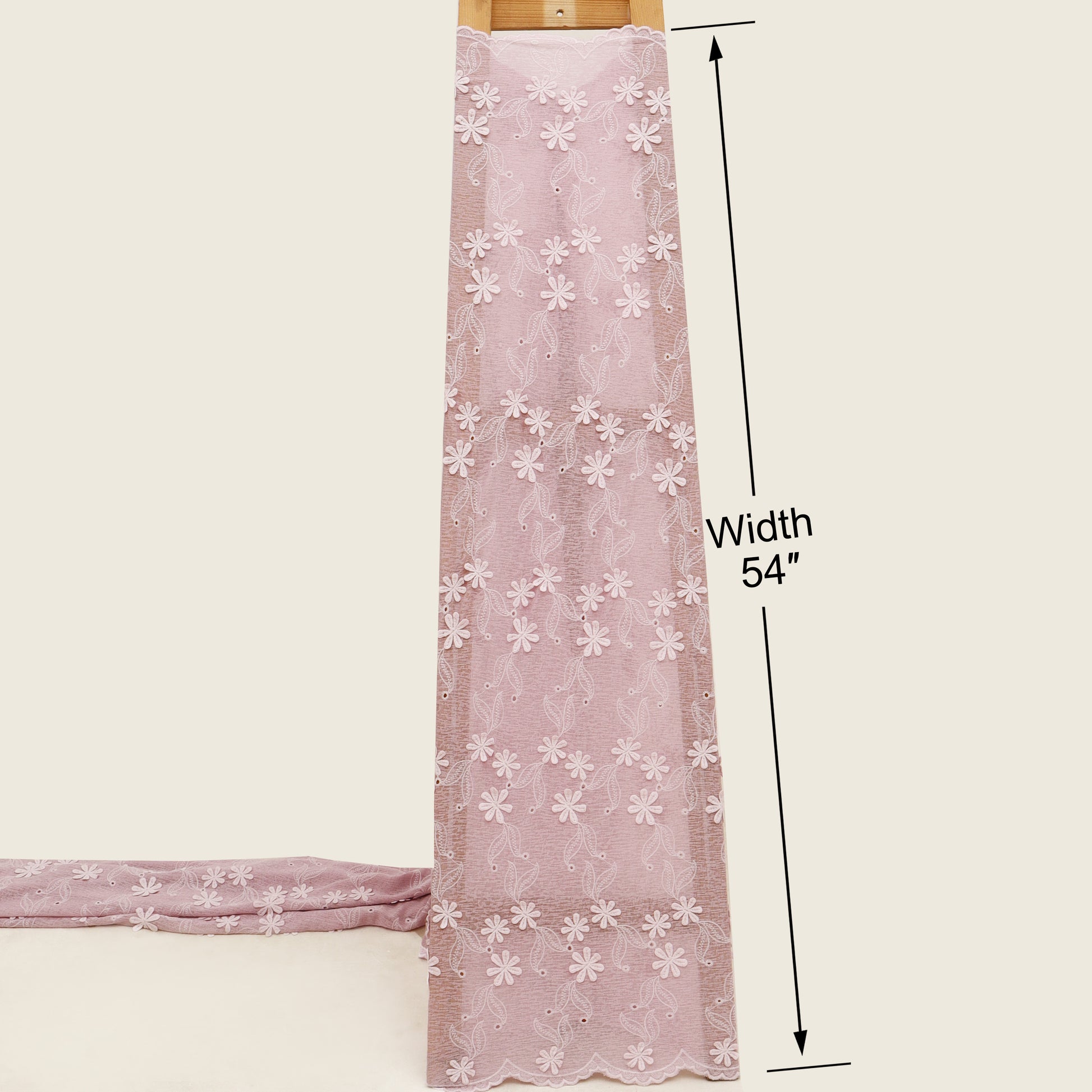 Pink lace fabric with white floral patterns and measurements on a beige background