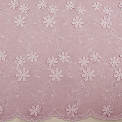 Embroidered lace fabric with white floral patterns on a pink background
