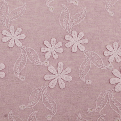 Embroidered floral pattern on a pink fabric background