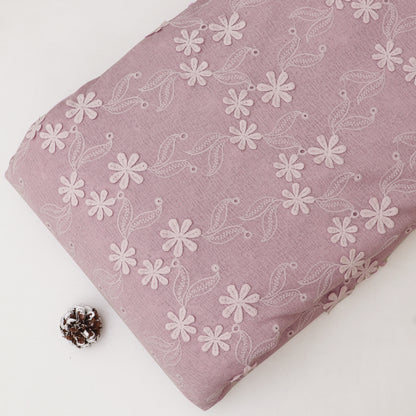 Pink fabric with white floral pattern on a white background