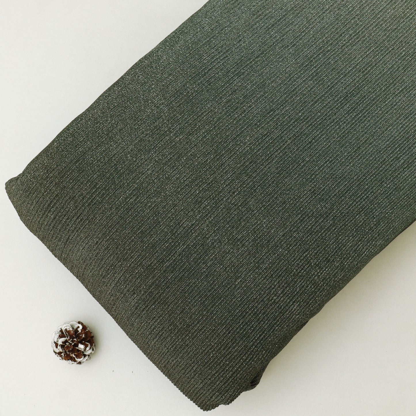Green fabric roll on a white background