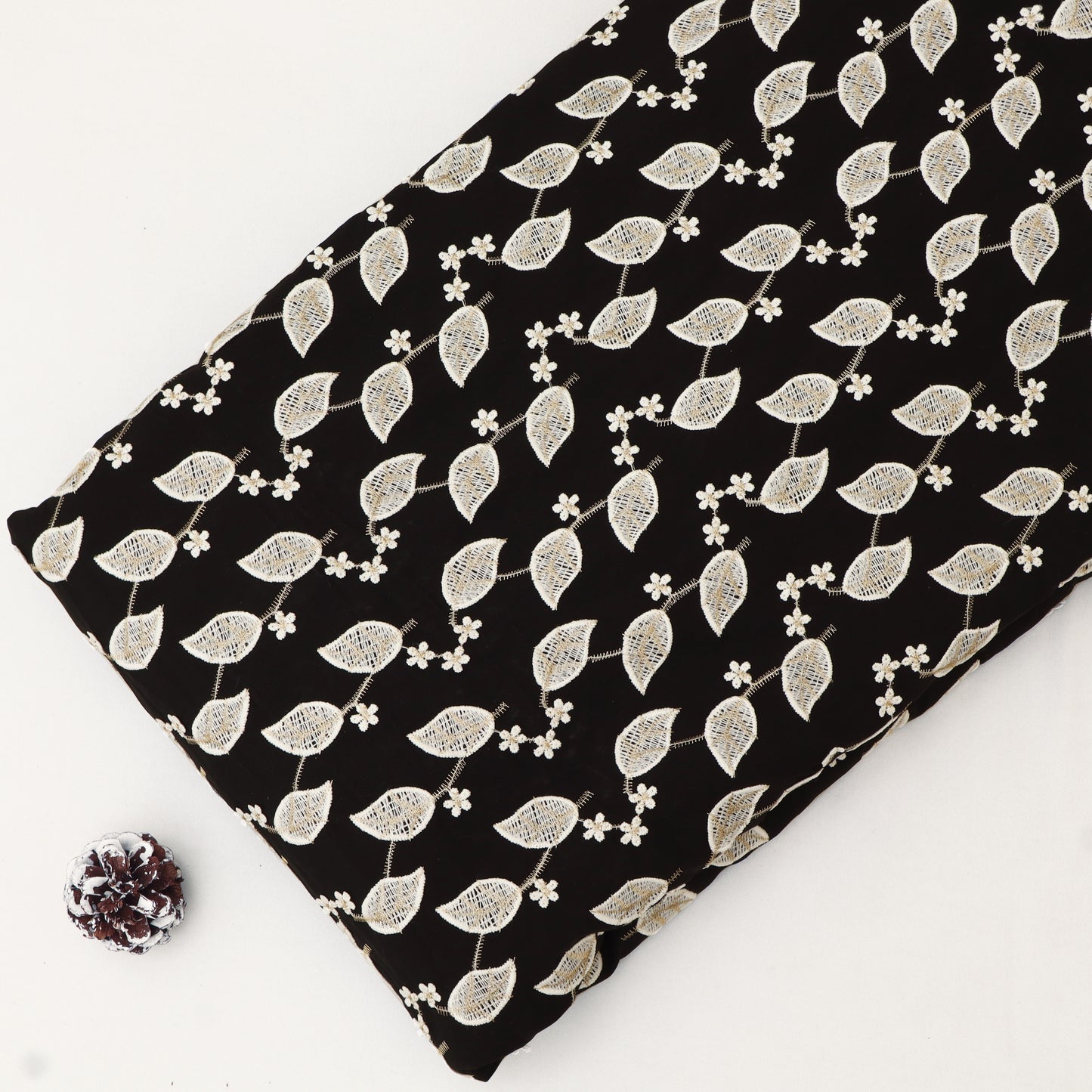 Fabric with white leaf pattern on black background