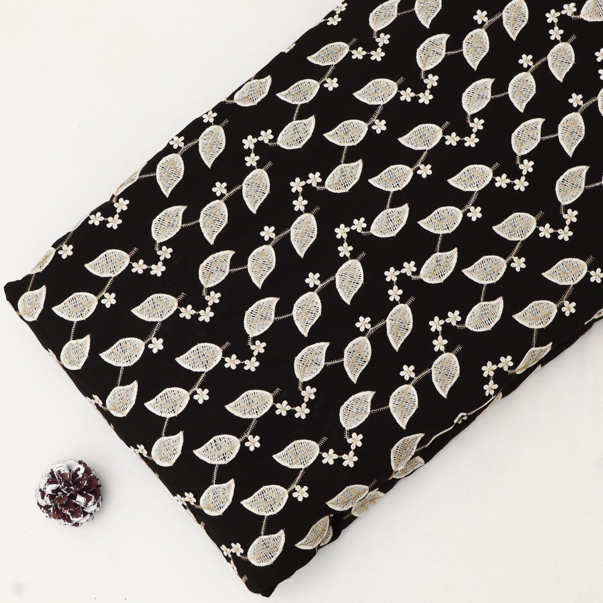 Fabric with white leaf pattern on black background