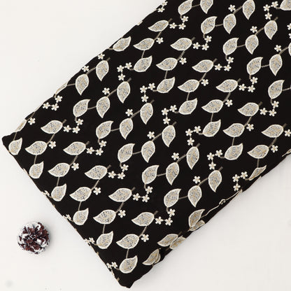 Fabric with white leaf pattern on black background