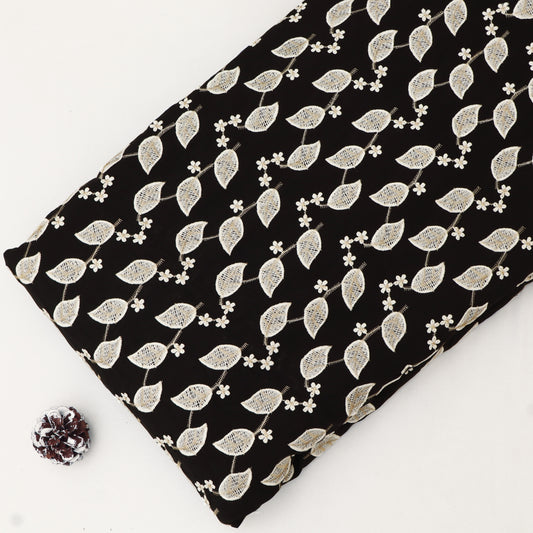 Fabric with white leaf pattern on black background