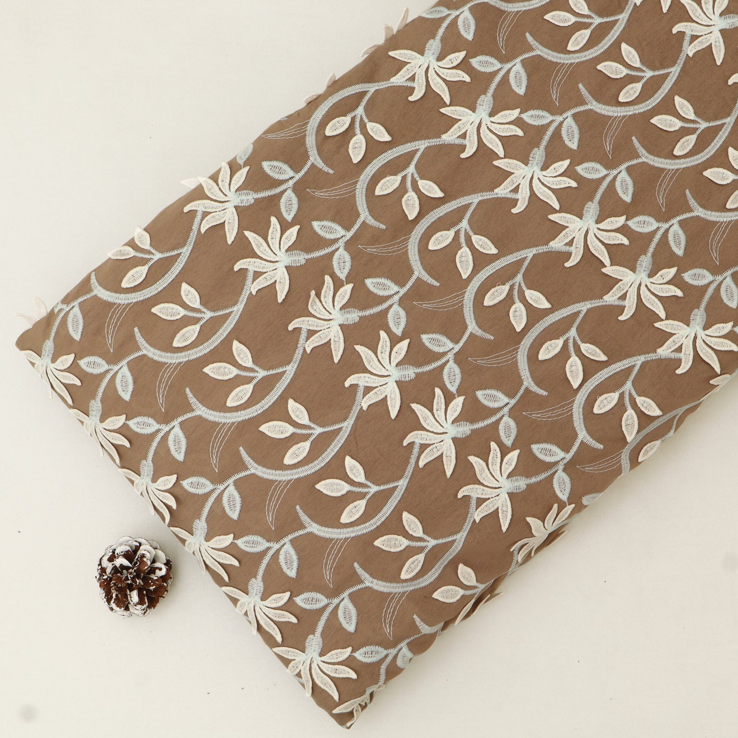 Fabric with floral pattern on a brown background
